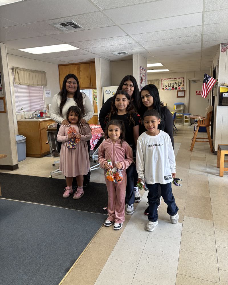 A mother and her children with Visitor Center staff.