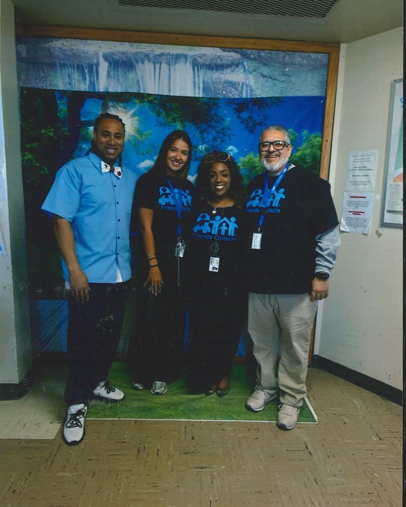 Four Friends Outside staff members at a prison Visitor Center.